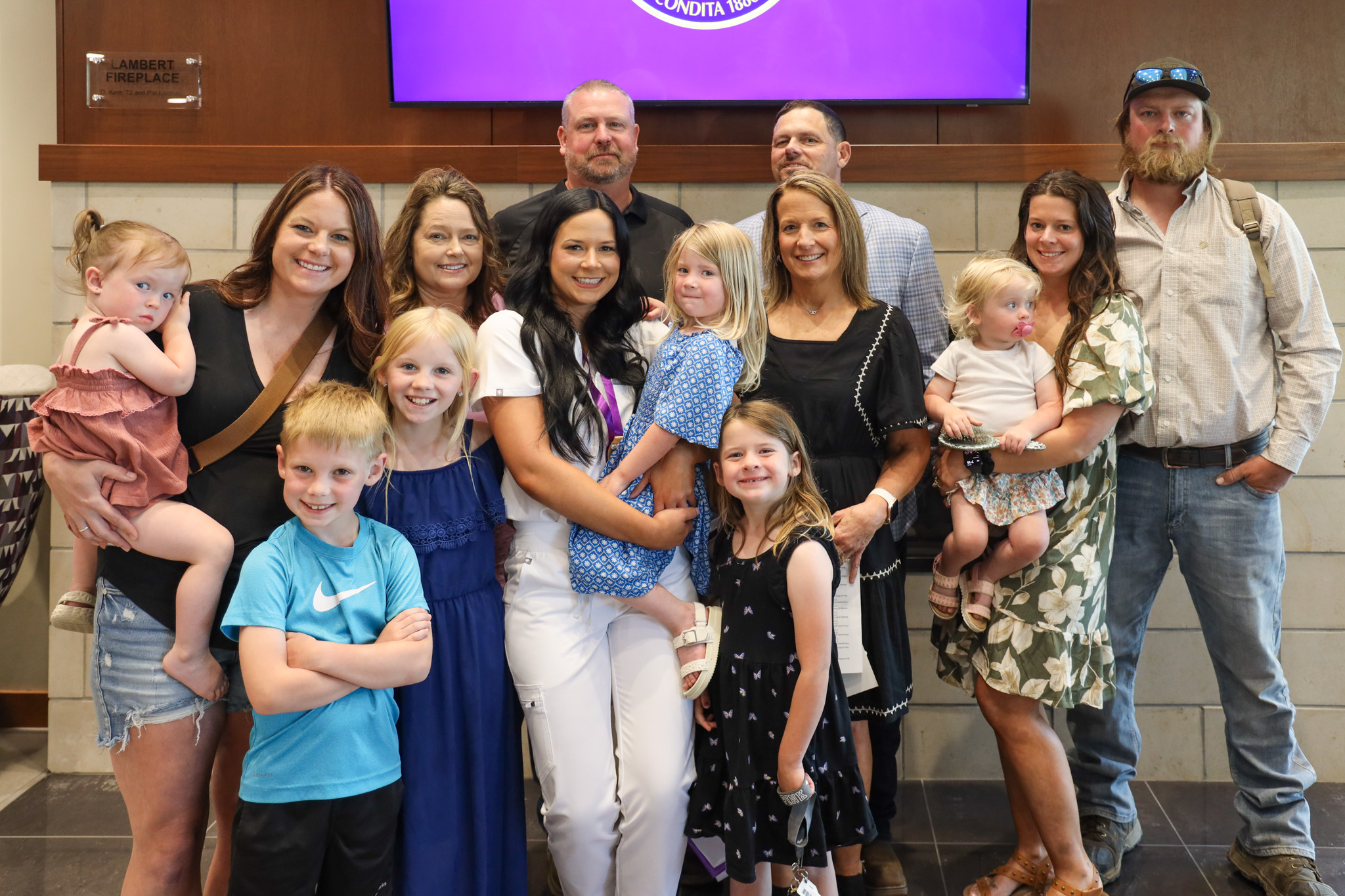 Family gathered together with Nursing grad