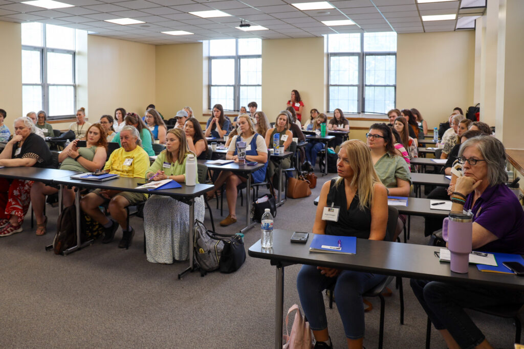 Group of people sitting in chairs in classroom
