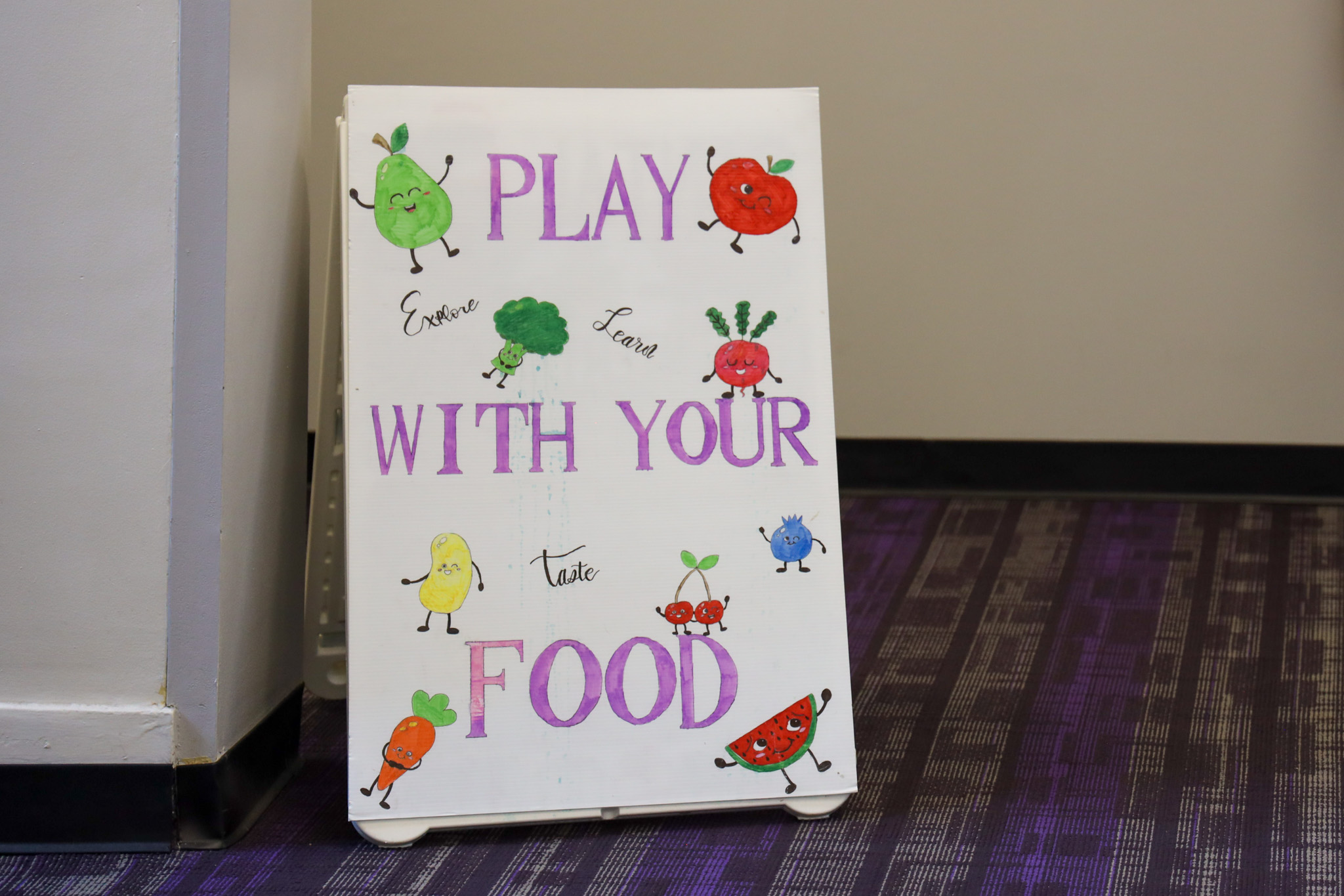White sign that says play with your food