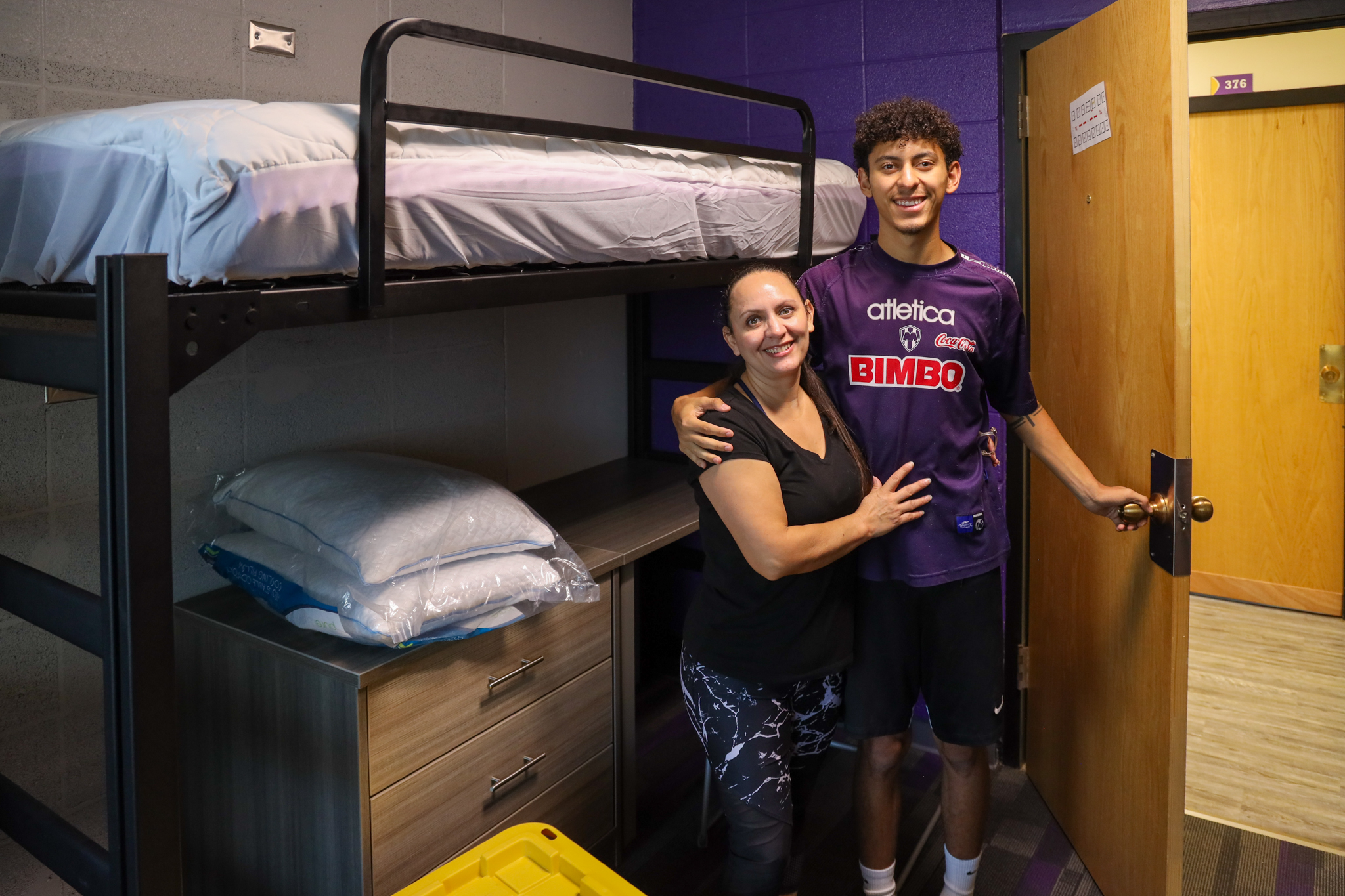 Male student with parent in dorm