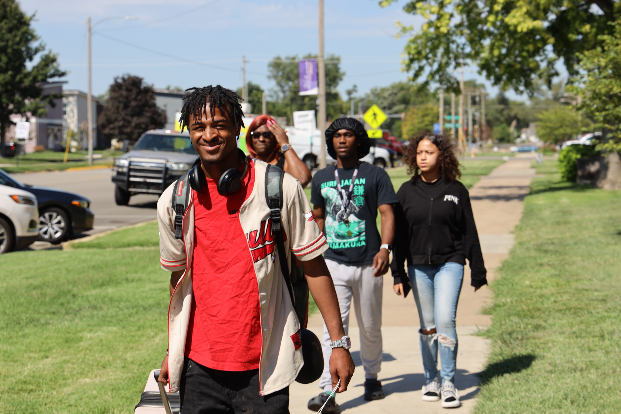 Group of people walking on sidewalk