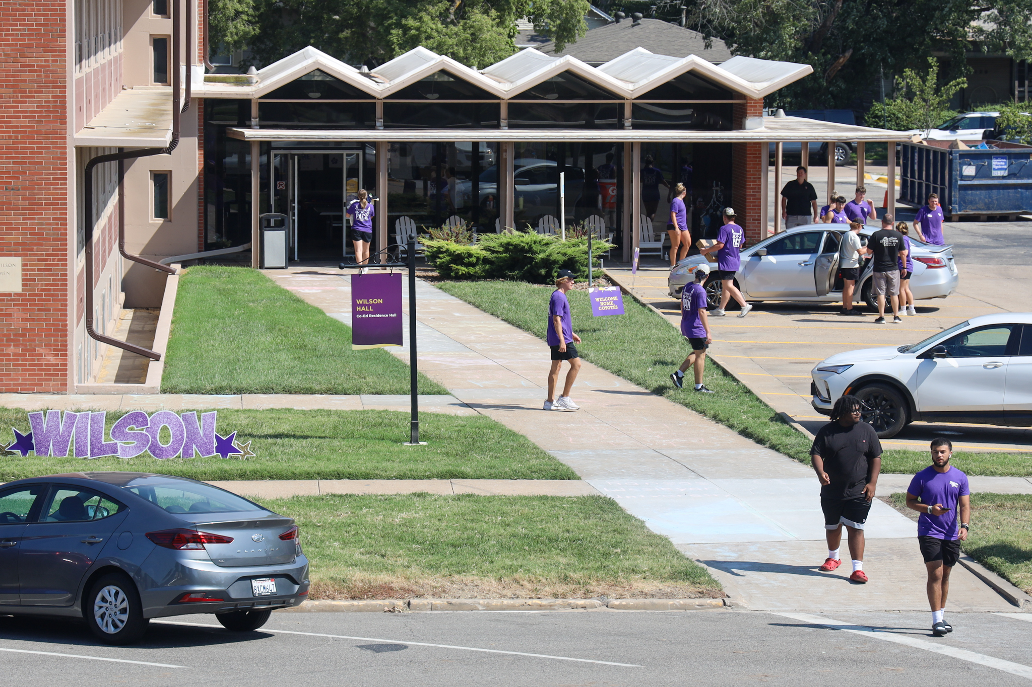Shot from second floor of res hall on students milling about
