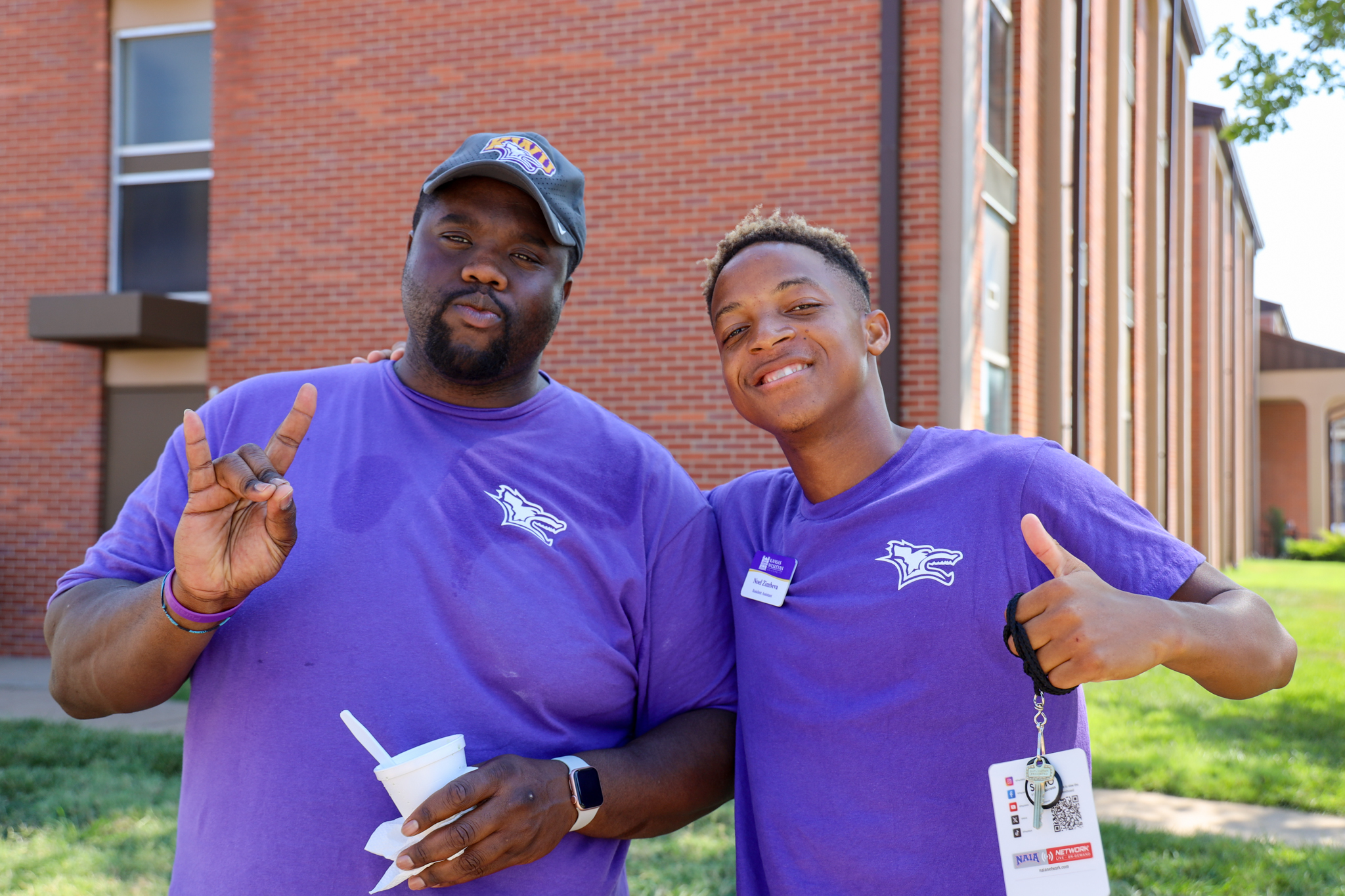 Male coach and student standing together