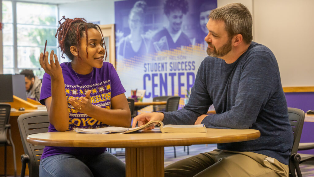 Student talking to employee