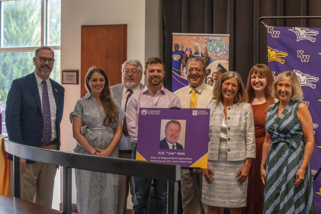 Large group together holding sign