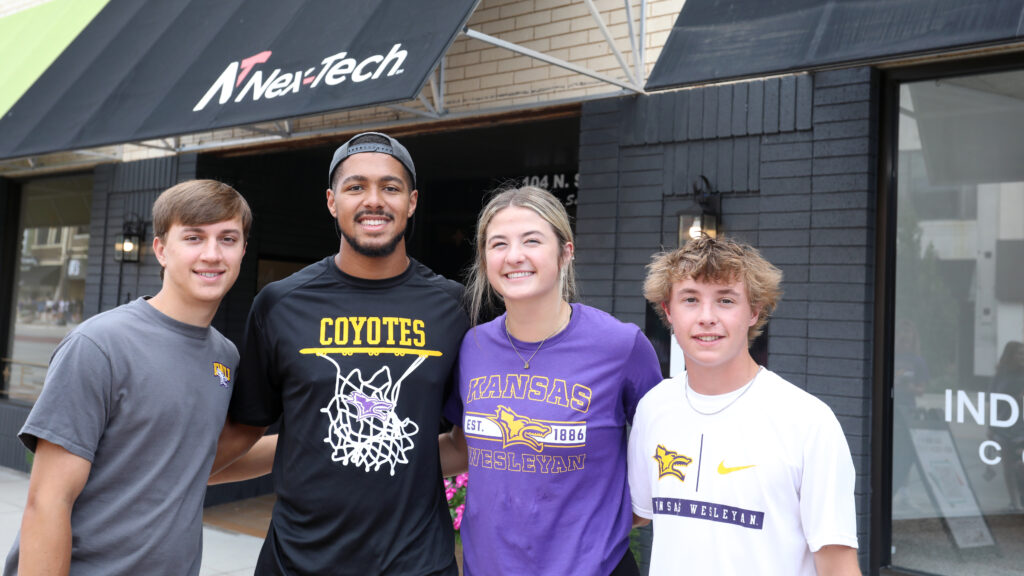Group of students downtown in front of awning