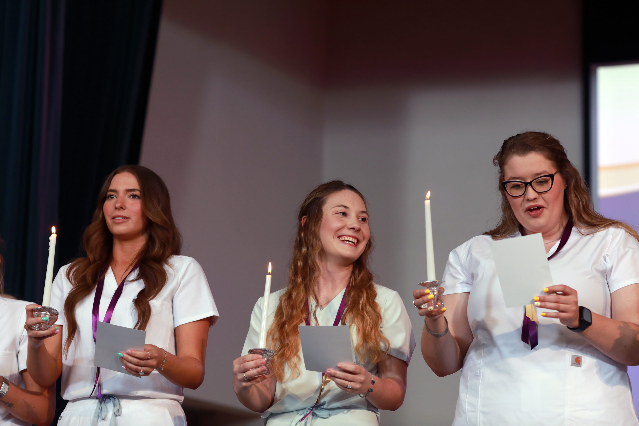 Group of nursing graduates with candles