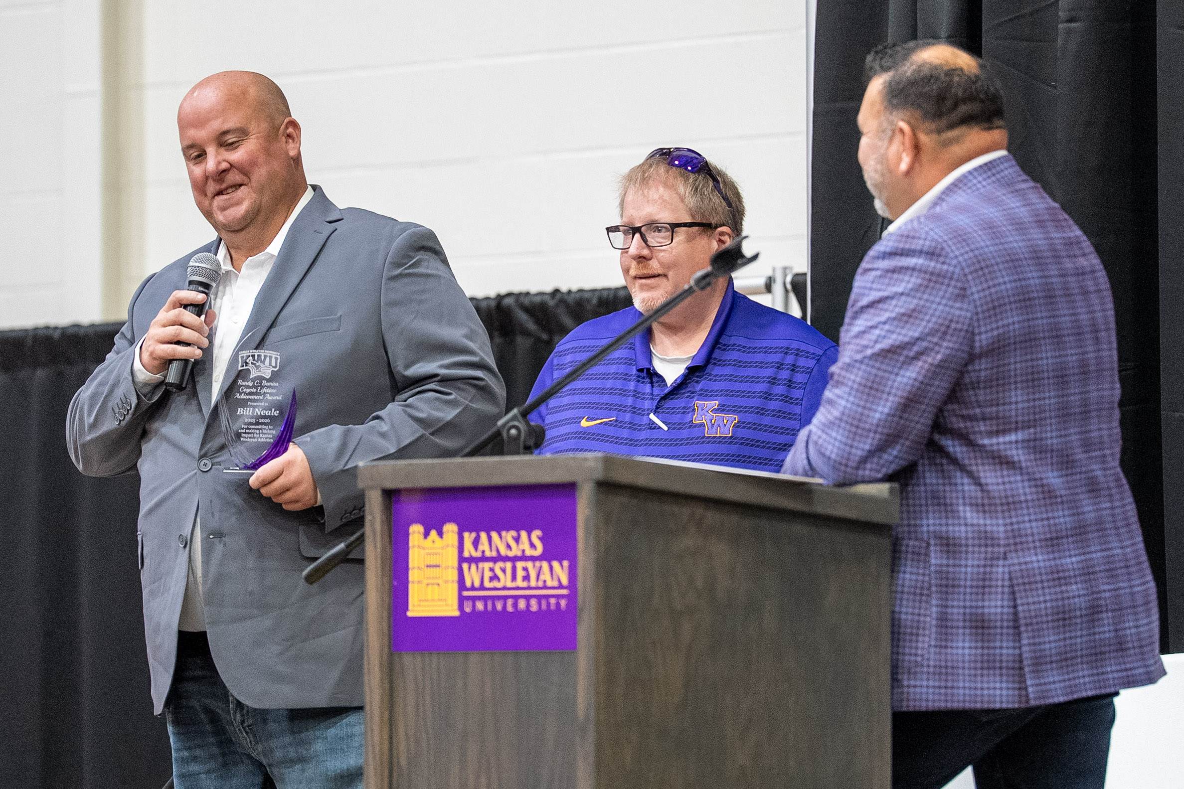 Man with microphone next to podium