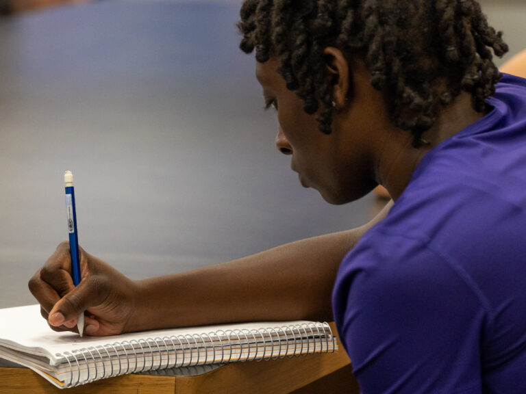 Student drawing on pad