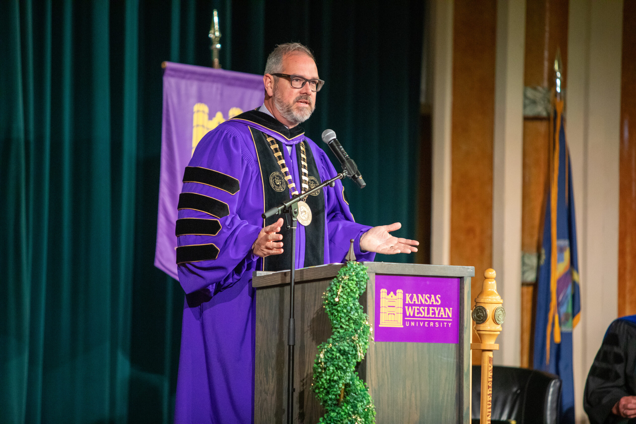 Man in presidential robe speaking at podium