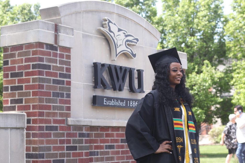 Grad with KWU sign