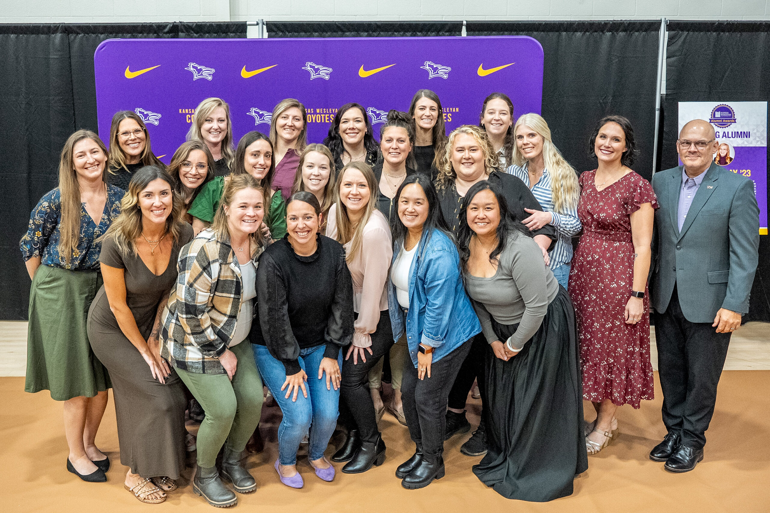 Group of women posing in front of backdrop