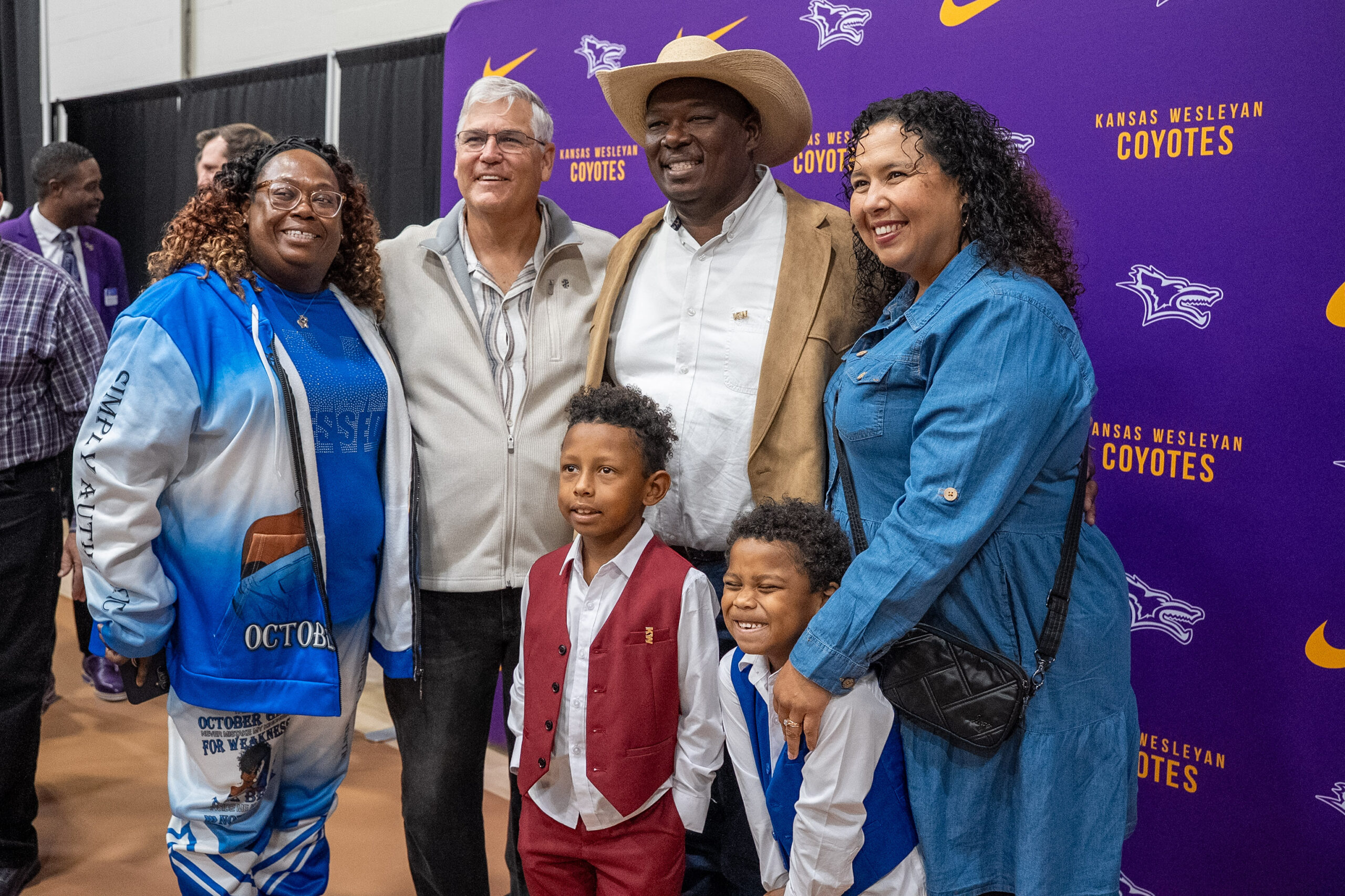 Group of individuals in front of backdrop