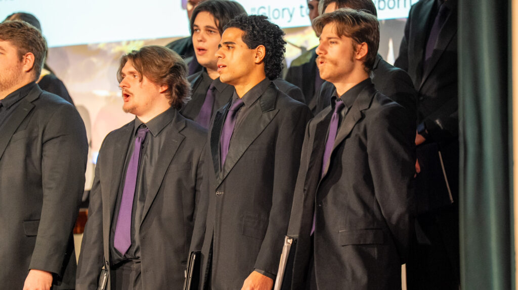 Group of men sining in black tie