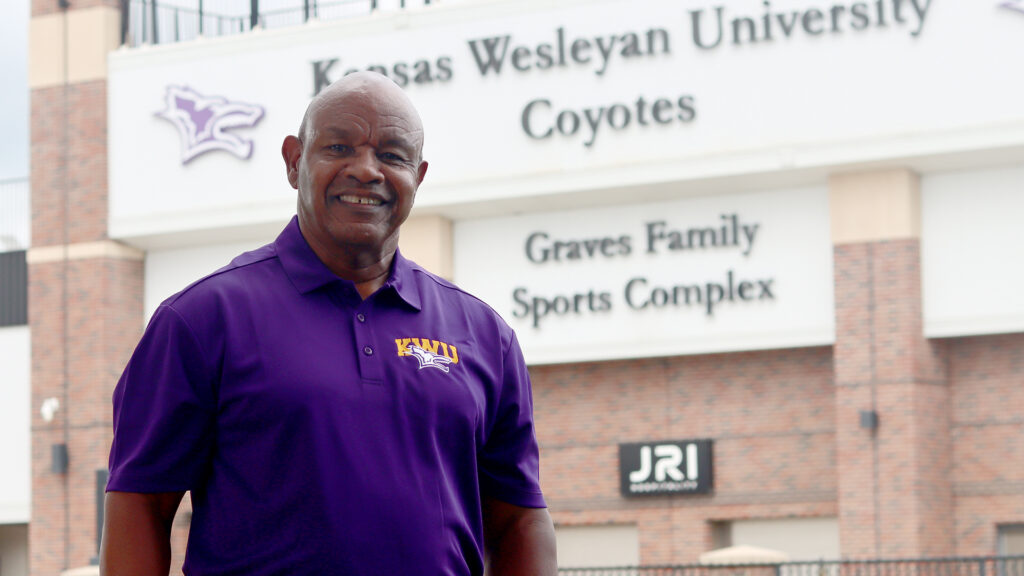 Man standing in front of football stadium