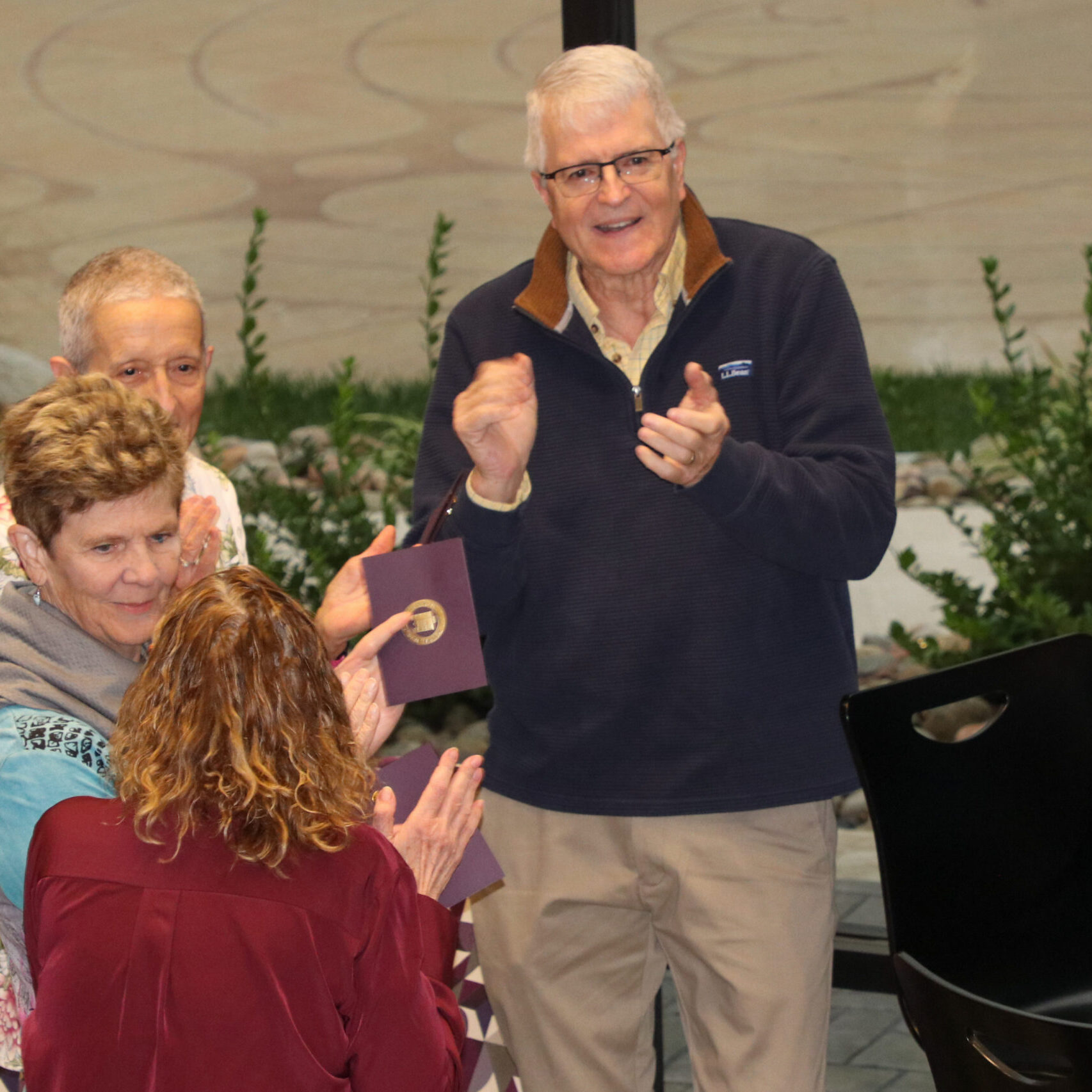 Man clapping in group of people