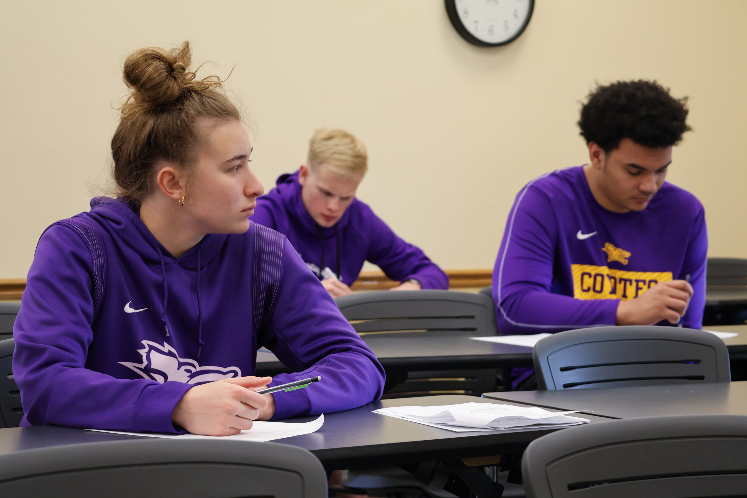 Students in classroom writing in notebooks