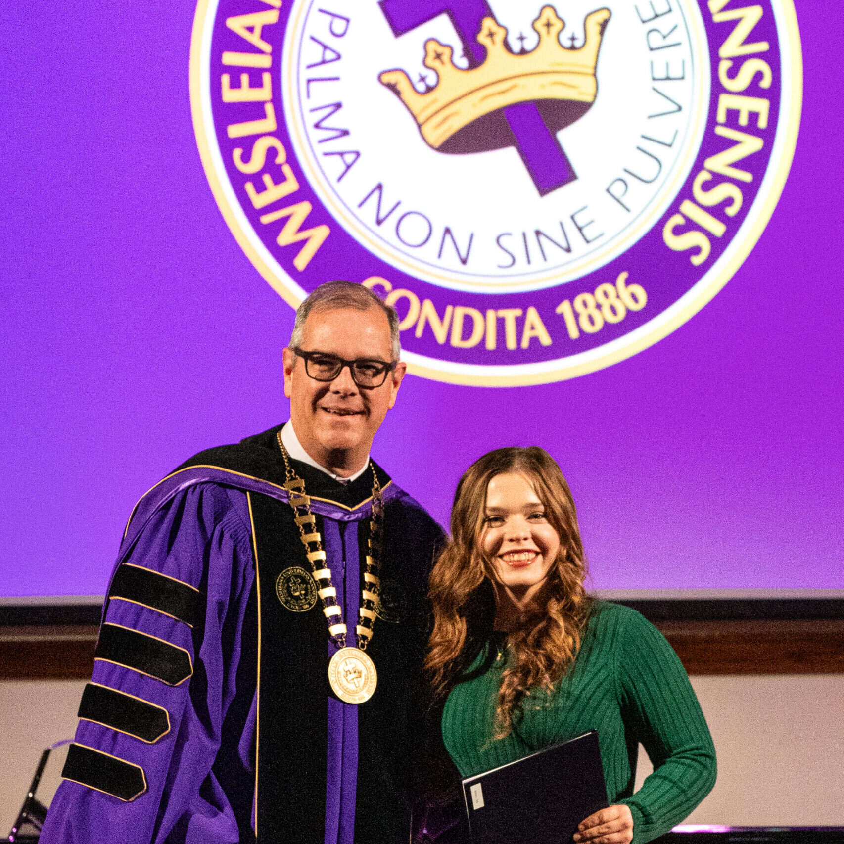 Female graduate with president