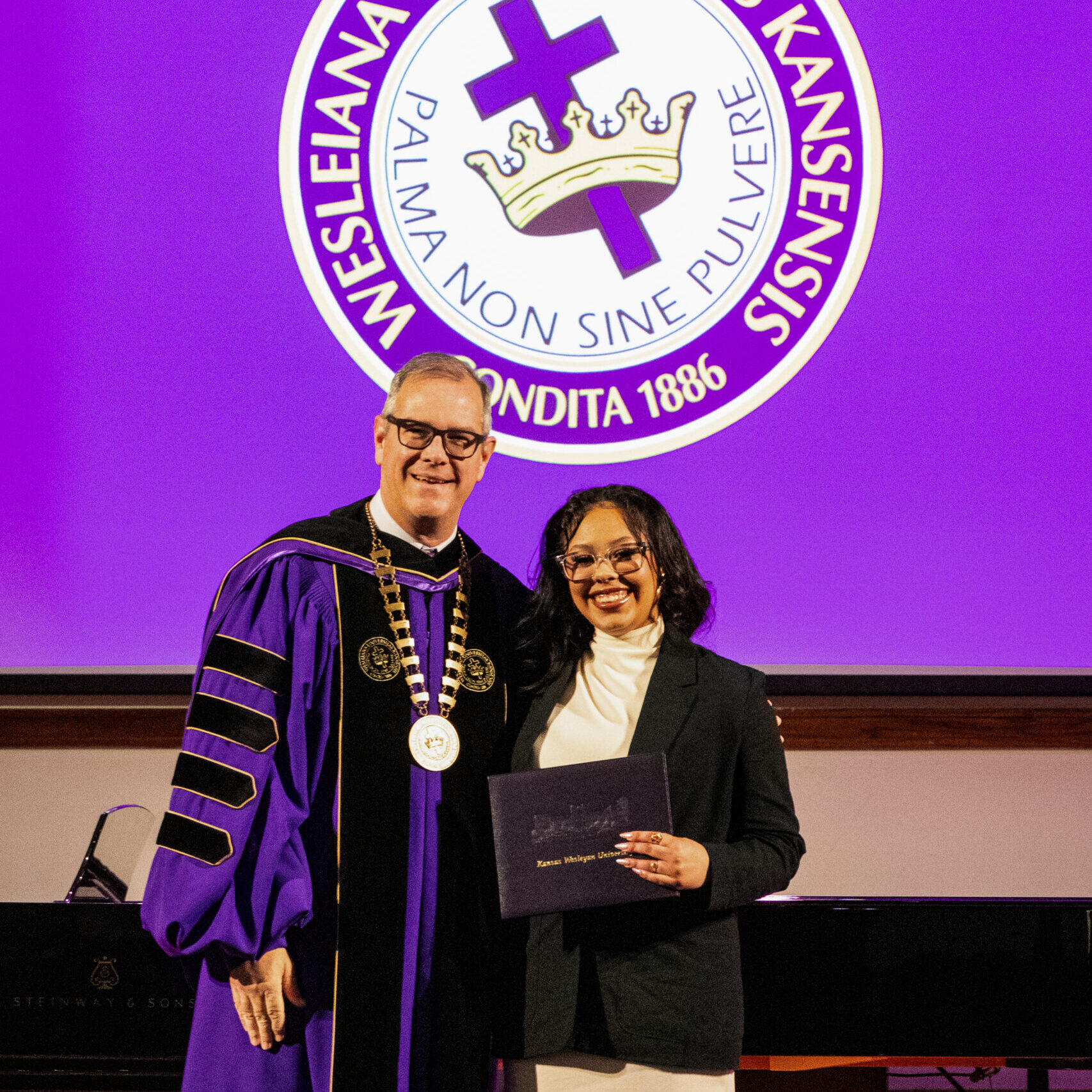 Female graduate with president
