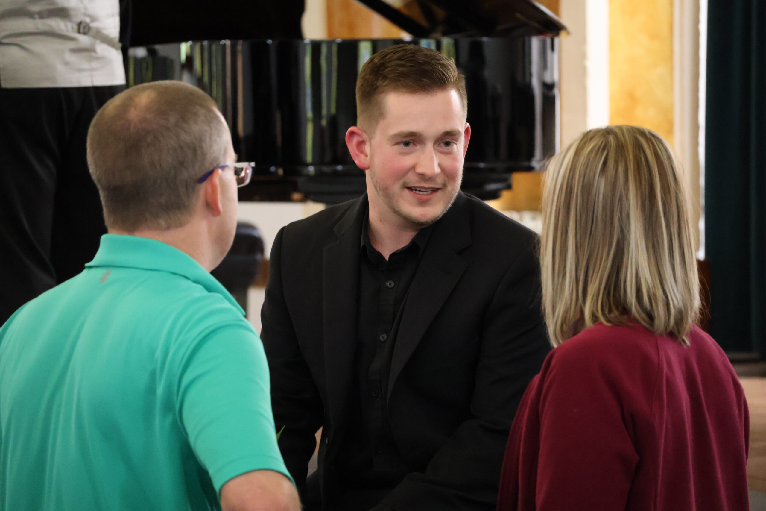Man speaking with other individuals