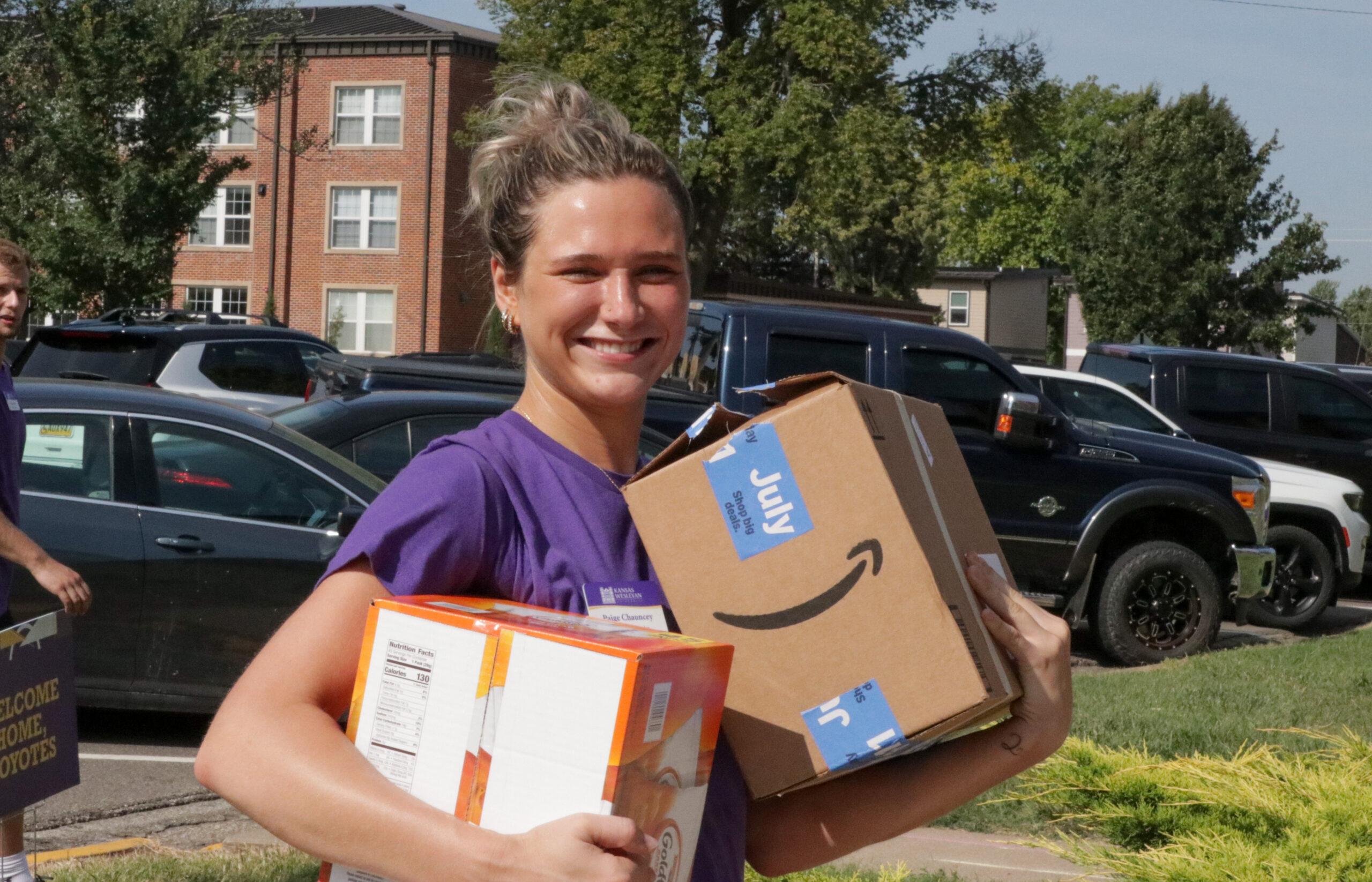 Female RA carrying boxes during move-in