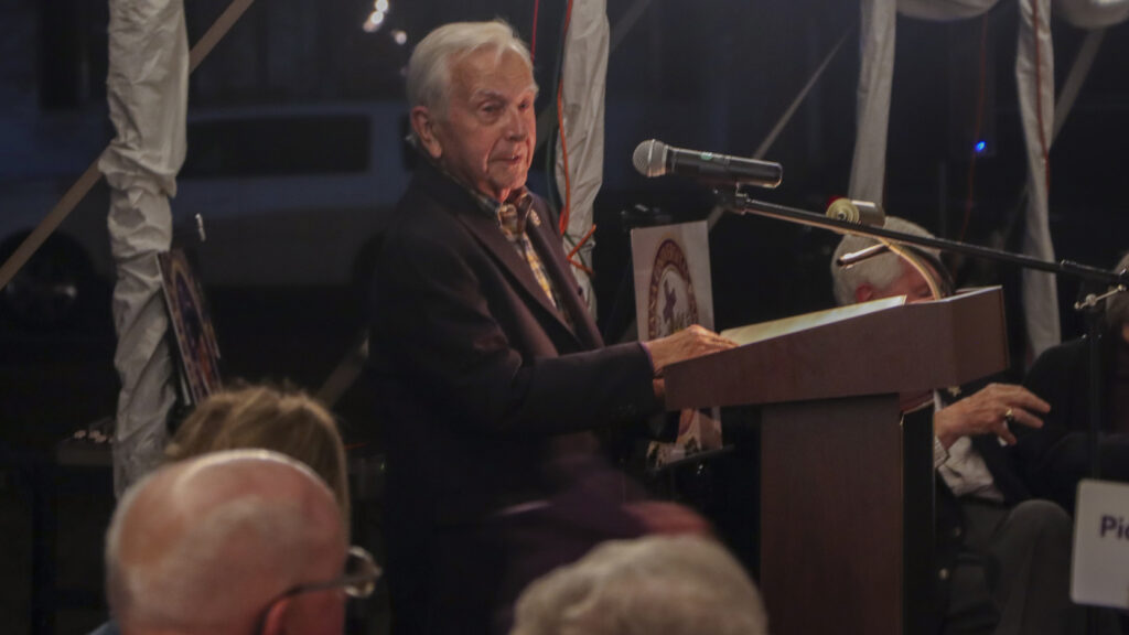 Man standing at podium talking