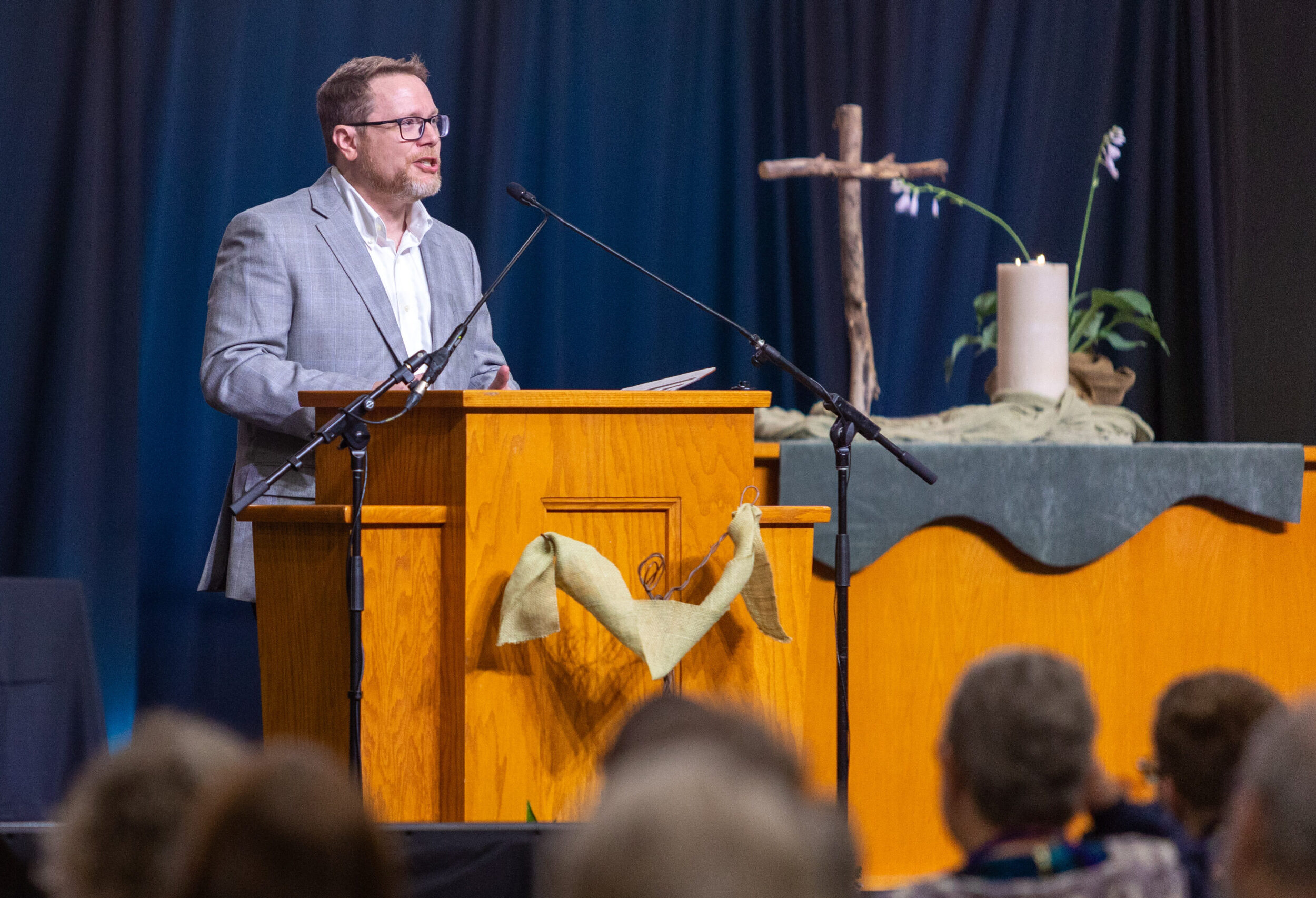 Man speaking from podium to conference