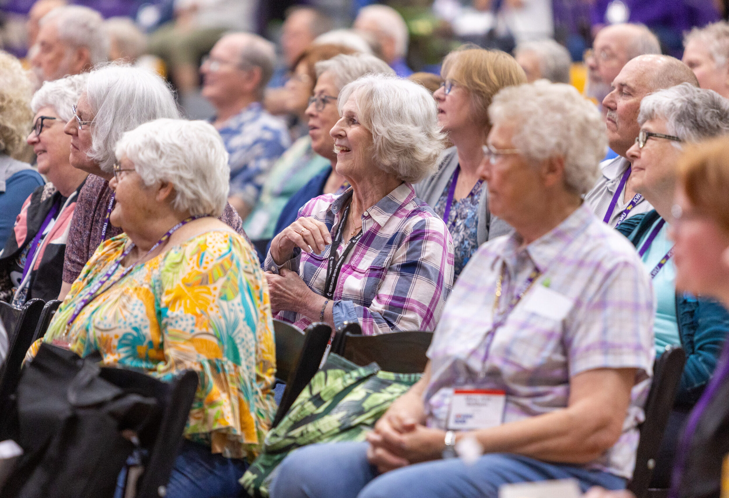 Group of people sitting in chairs listening
