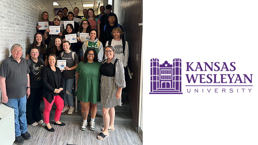Students in hallway on stairs with logo